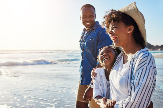 Family, travel and walking on a beach with adorable child on vacation