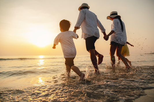 Happy family having fun playing beach in summer vacation on the beach.