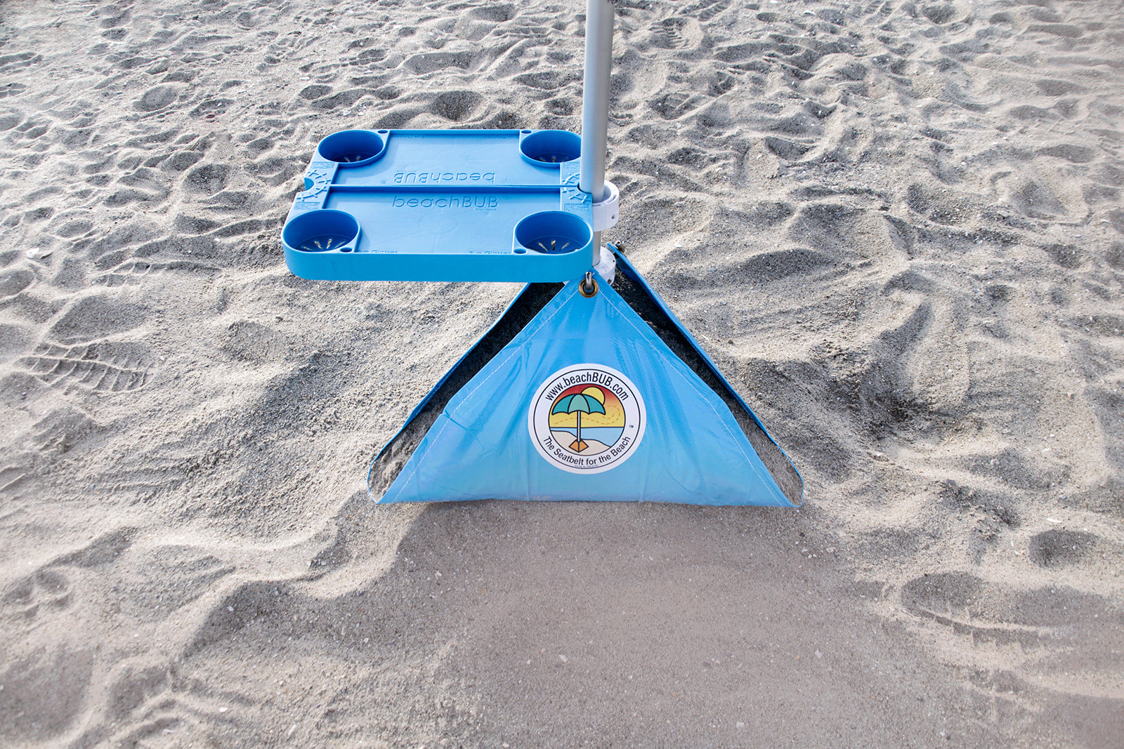 beach umbrella tray table system set up above windproof beach umbrella base