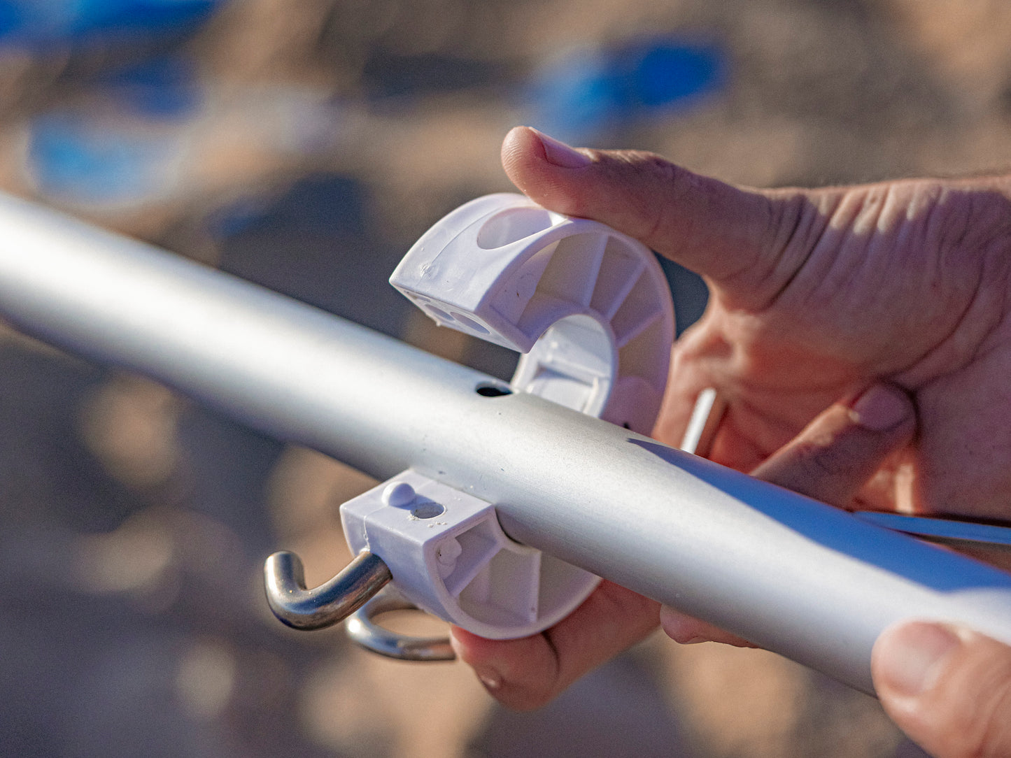 snapping umbrella collar onto beach umbrella pole