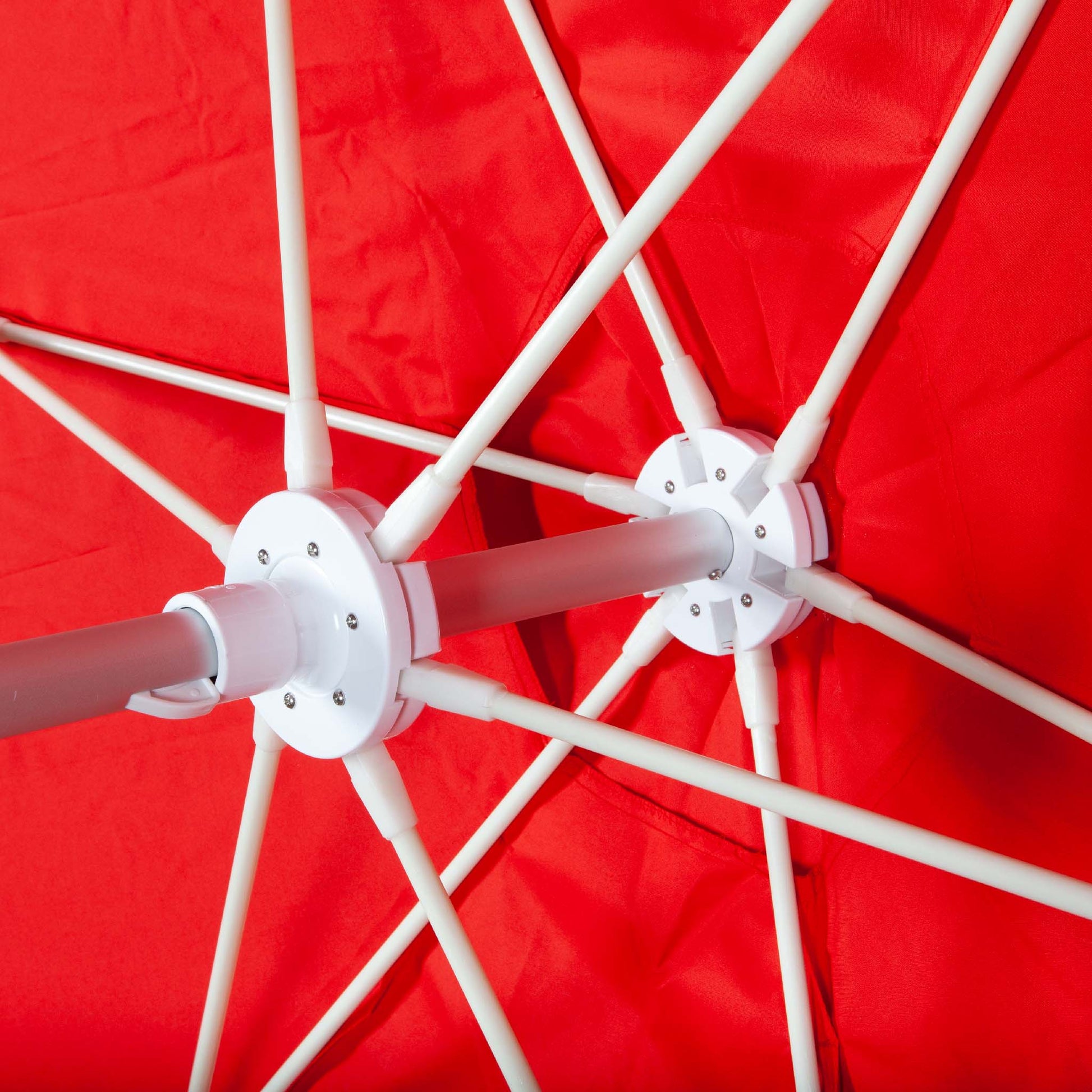 underneath red beach umbrella canopy