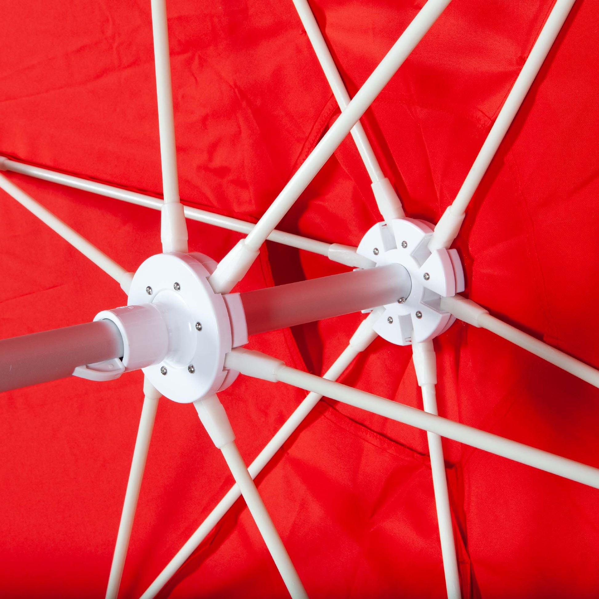 underneath red beach umbrella canopy