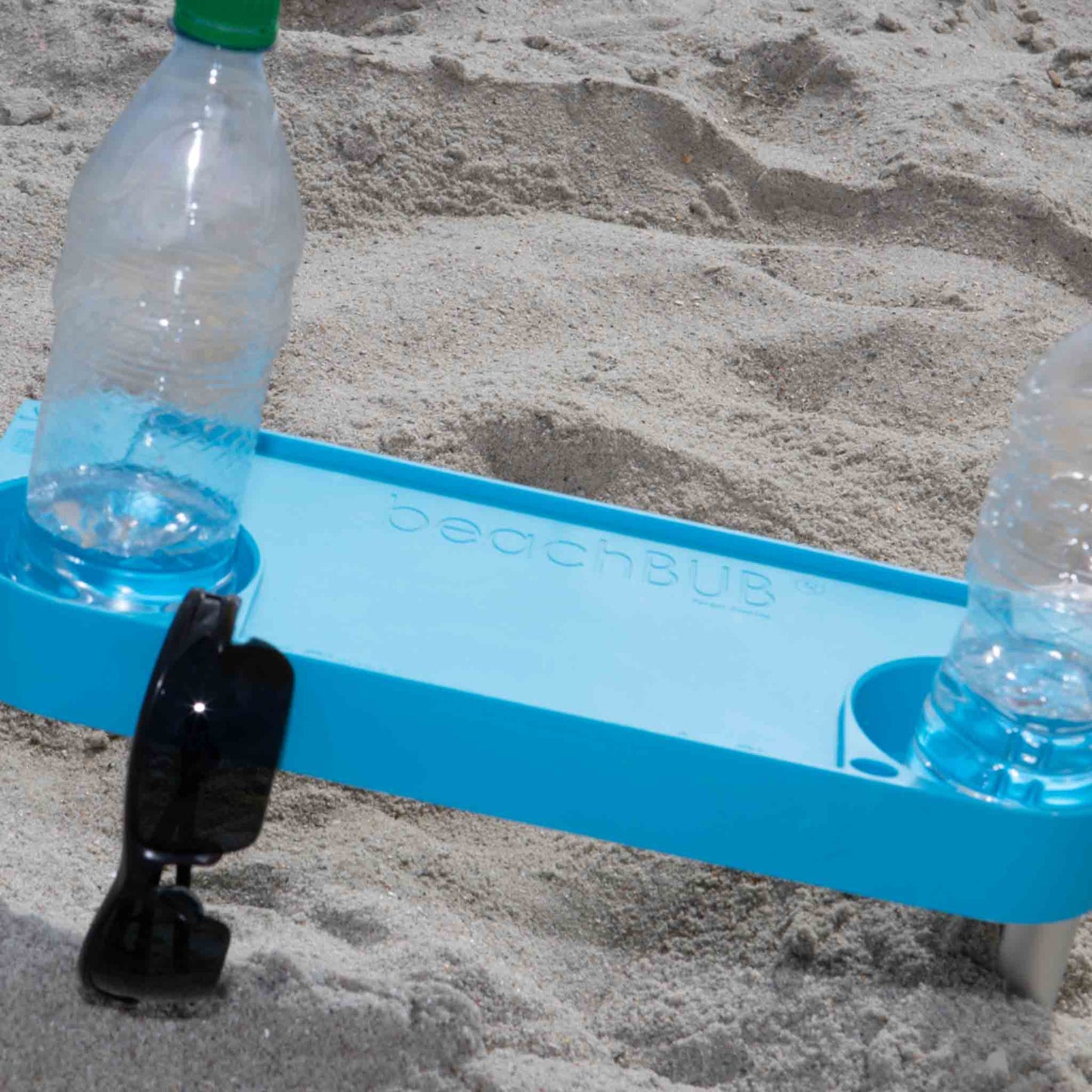 beach umbrella tray table with two water bottles and sun glasses